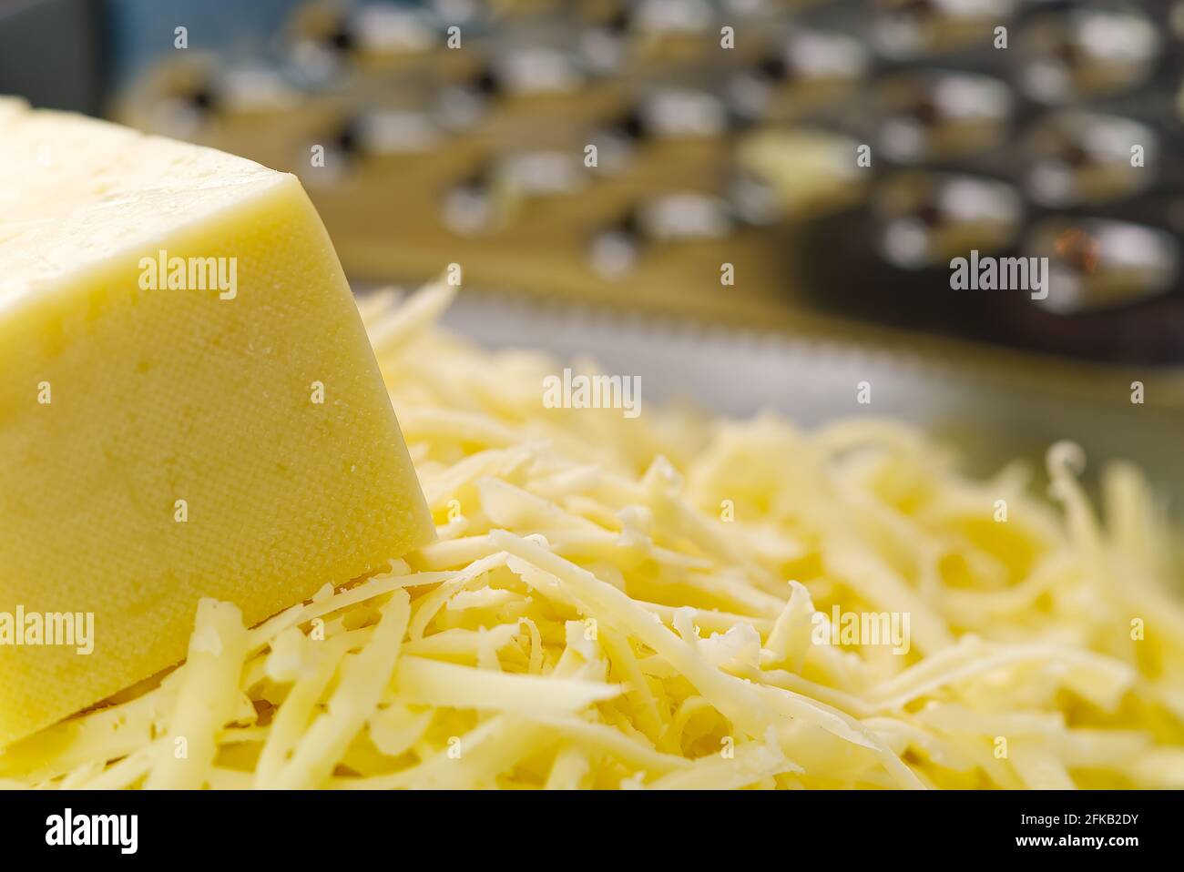 Cheese and Grated cheese, close-up. blurred background Stock Photo