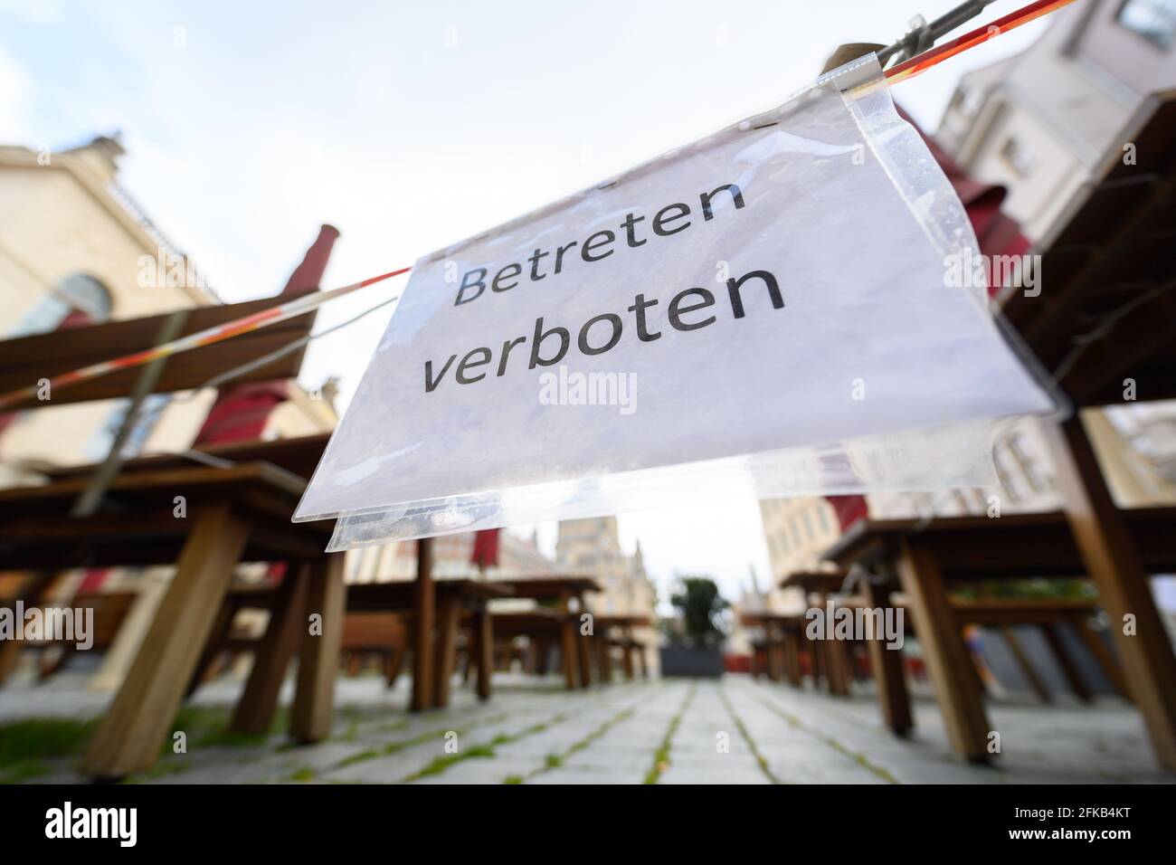 30 April 2021, Saxony, Dresden: Outdoor seats of a restaurant on the Neumarkt are cordoned off with barrier tape and 'Do not enter' notices. Photo: Robert Michael/dpa-Zentralbild/dpa Stock Photo