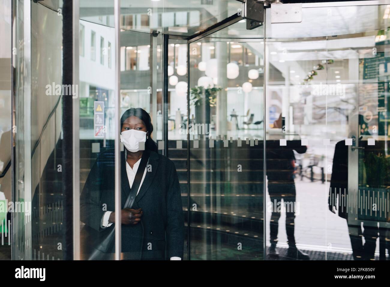 Mature businesswoman in shopping mall during COVID-19 Stock Photo