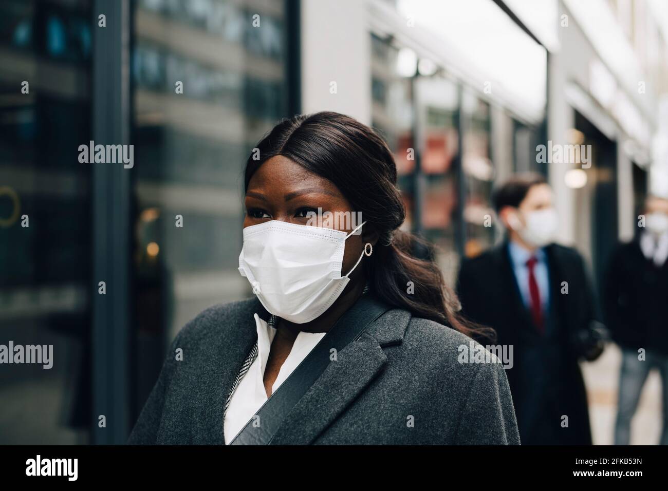 Female entrepreneur looking away during pandemic Stock Photo