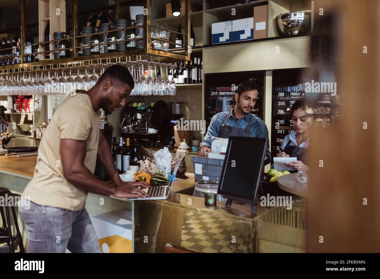 Male and female colleagues working in deli store Stock Photo Alamy