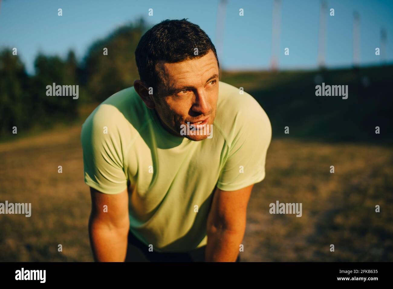 Male athlete looking away during sunset Stock Photo