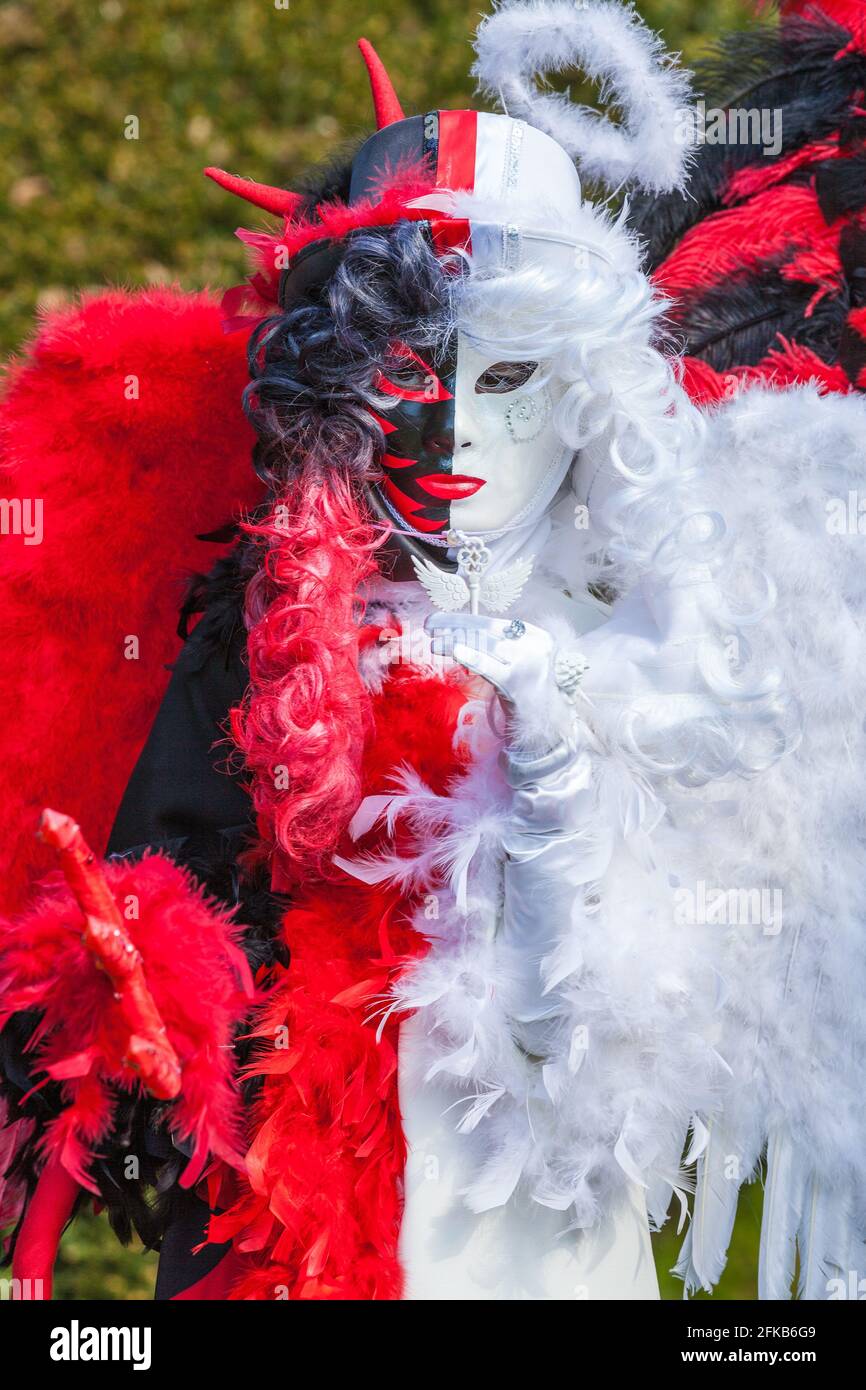 White and red venetian costume, angel and devil Stock Photo