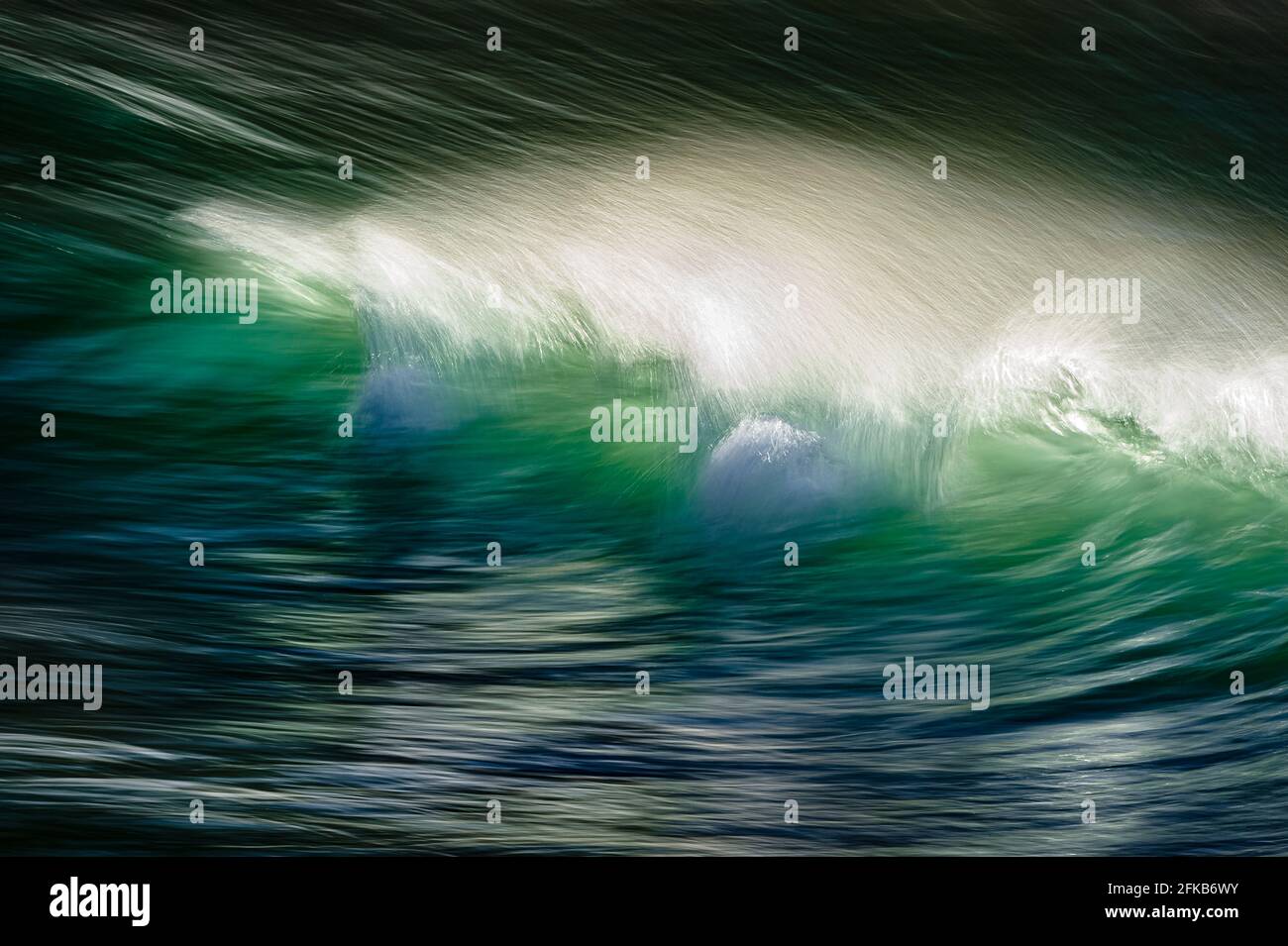 Crest of a wave as it splashes and crashes in Victoria Bay, Western Cape Stock Photo