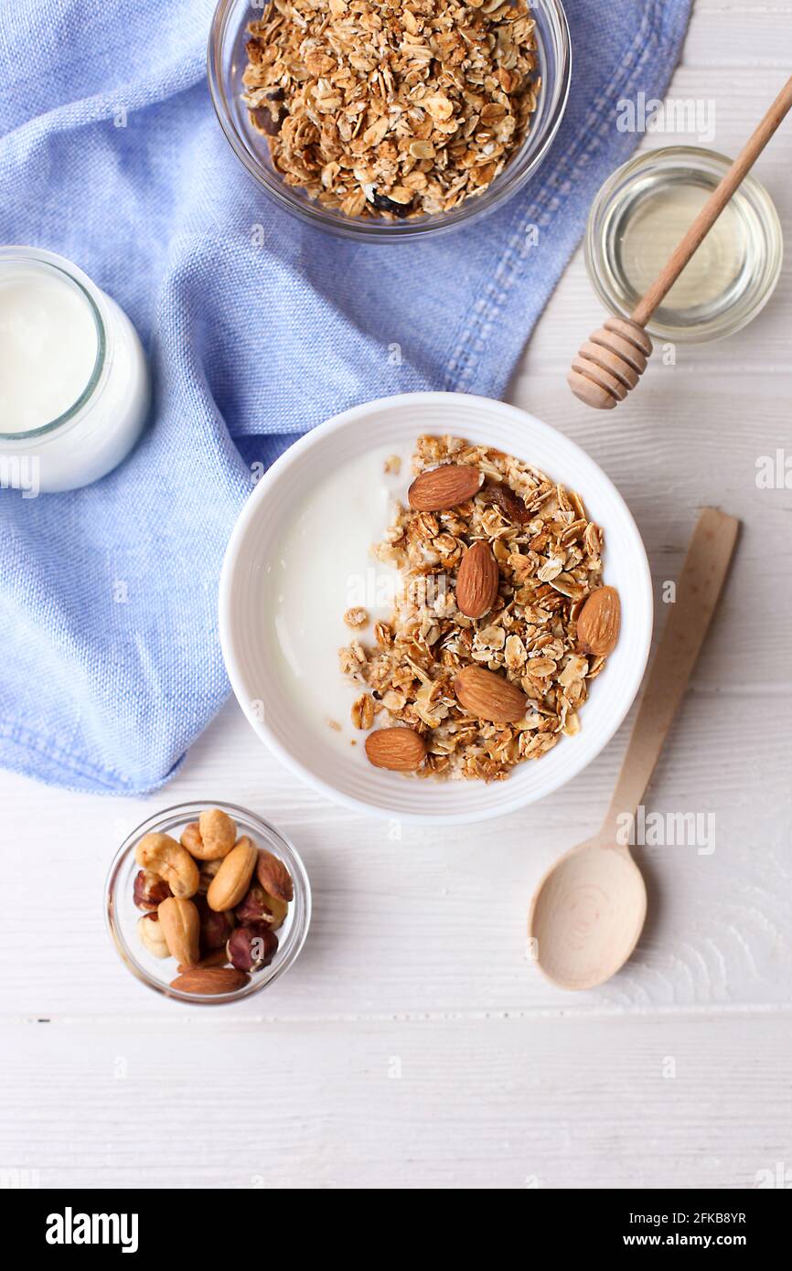 Ceramic bowl of Greek yogurt and mixed nuts. Nutritious vegetarian