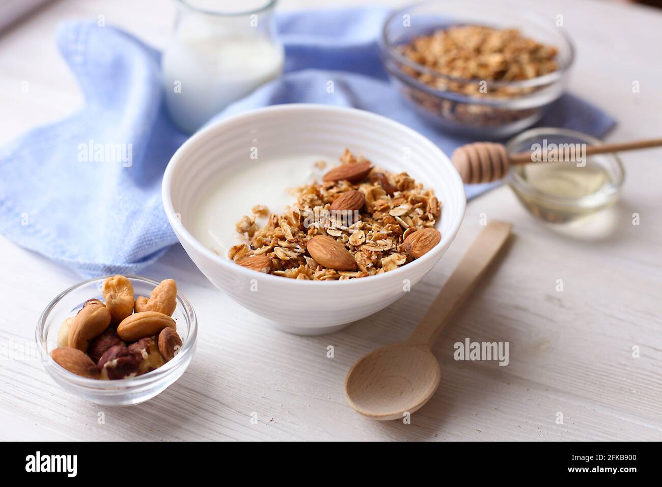 Ceramic bowl of Greek yogurt and mixed nuts. Nutritious vegetarian