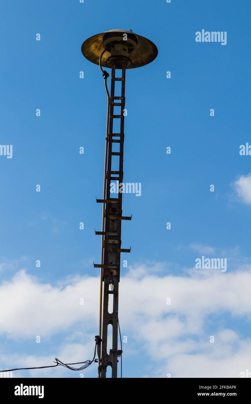 Civil defense siren on top of tall pillar post in Brennbergbanya, Sopron, Hungary Stock Photo