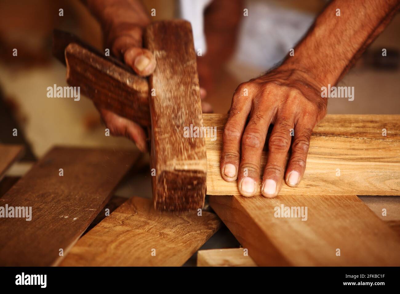 Royalty free photo of carpenter making modern Teak Wood pasted panel