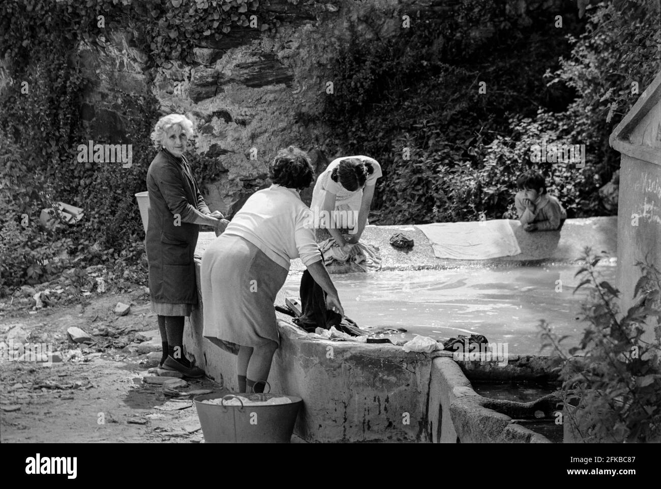 SPAIN - Galicia - 1970. Women washing clothes at the village spring and washing area in the village of Lorbe near A Coruña, Galicia, North west Spain. Stock Photo
