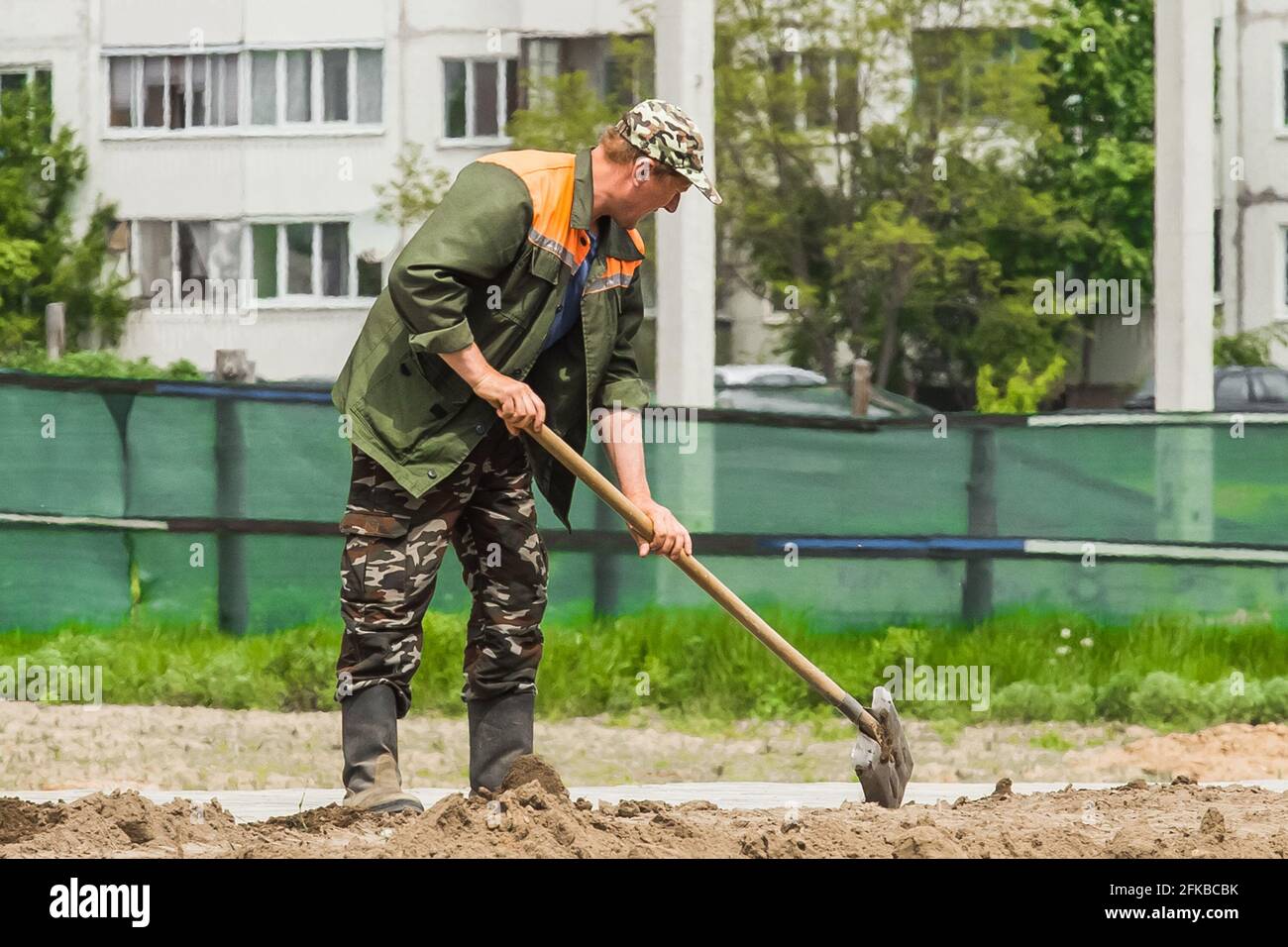 Belarus, Minsk - May 28, 2020: Industrial male worker digging earth ...