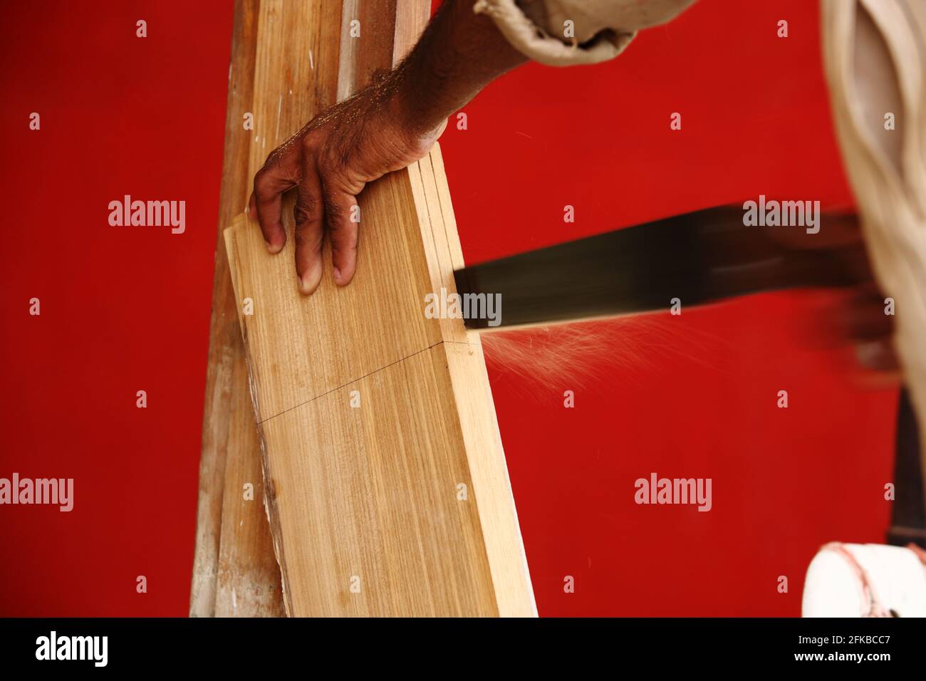 Carpenter is cutting a plank teak wood for a window Stock Photo Alamy
