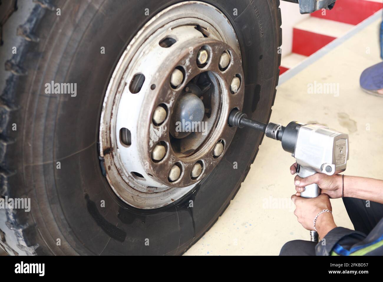 Man is changing tires of heavy goods vehicle (truck) with Impact wrench  A.K.A impactor, air wrench, air gun, rattle gun, torque gun Stock Photo -  Alamy