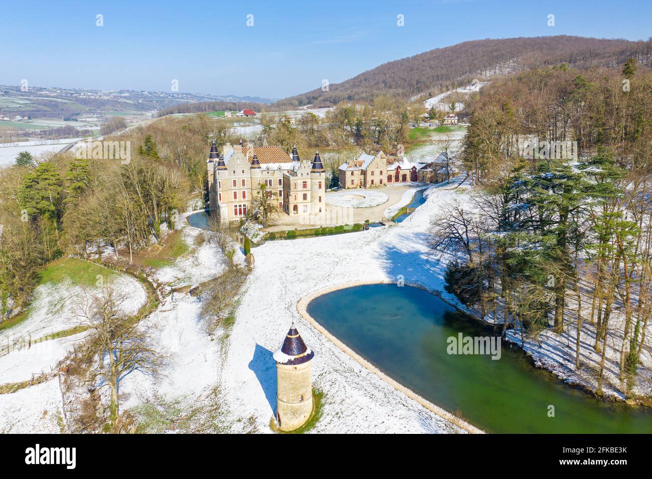 Drone Aerial Shot of Castle Palace located in front of lake in the middle of forest on the outskirts of a small town in france in front of a lake. Stock Photo