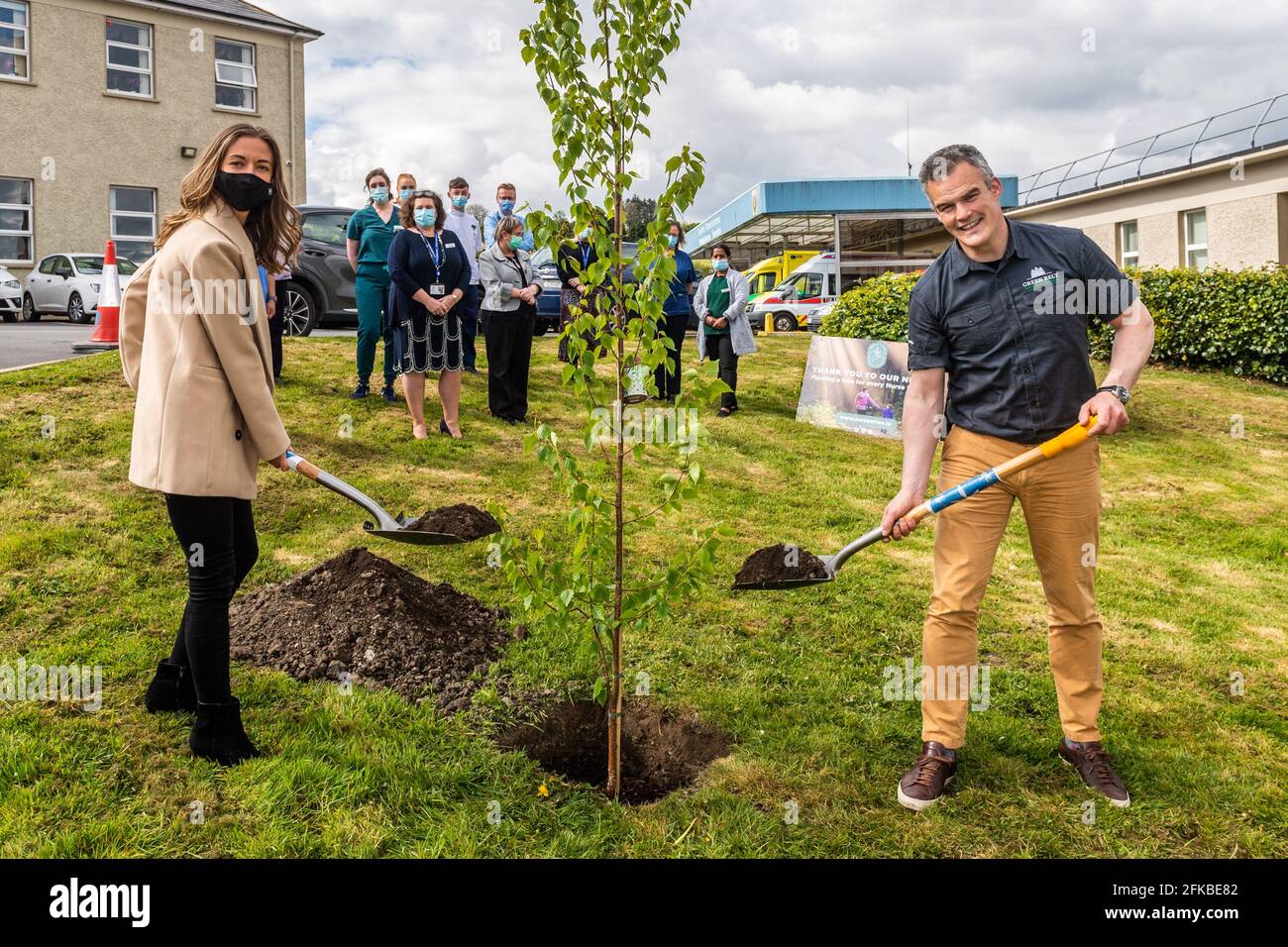 Bantry, West Cork, Ireland. 30th Apr, 2021. Holly Cairns TD planted a birch and oak tree at Bantry General Hospital today as part of the 'Nurse a Tree' initiative. Nurse a Tree plans to plant a tree for every healthcare worker in Ireland, which amounts to 80,000, as a living legacy. Assisting Holly with the planting of a birch tree is Maurice Ryan, Director of Green Belt LTD with Bantry Hospital Nurses watching on. Credit: AG News/Alamy Live News Stock Photo