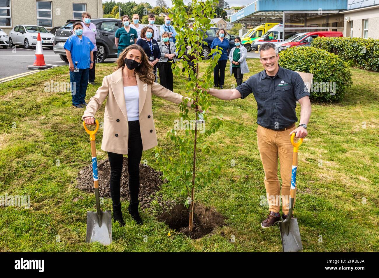Bantry, West Cork, Ireland. 30th Apr, 2021. Holly Cairns TD planted a birch and oak tree at Bantry General Hospital today as part of the 'Nurse a Tree' initiative. Nurse a Tree plans to plant a tree for every healthcare worker in Ireland, which amounts to 80,000, as a living legacy. Assisting Holly with the planting of a birch tree is Maurice Ryan, Director of Green Belt LTD with Bantry Hospital Nurses watching on. Credit: AG News/Alamy Live News Stock Photo