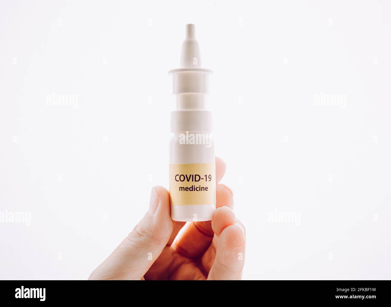 Person holding new treatment against Coronavirus COVID-19 nasal spray. Conceptual image of person hand holding new innovative nasal spray bottle with Stock Photo