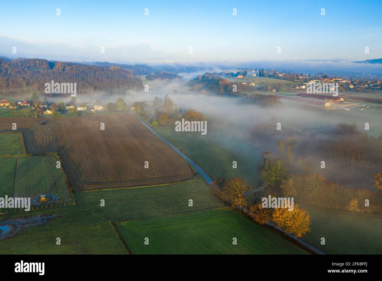 Drone shot of town on a misty foggy morning. Stock Photo