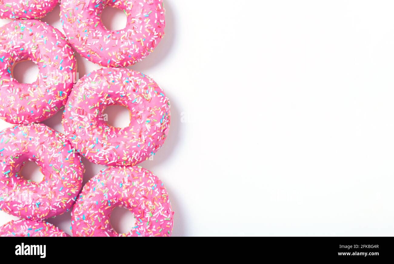 Left donuts border. Top view of yummy fresh homemade doughnuts. Light
