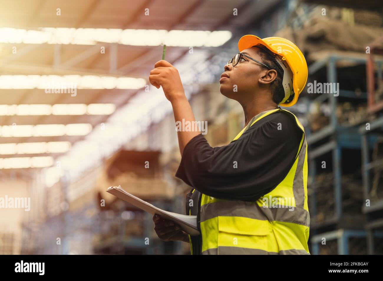 Black African professional women worker working count checking inventory production stock control in business factory  industry warehouse waring engin Stock Photo
