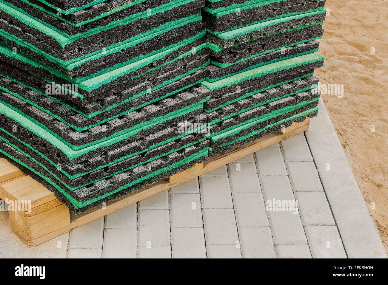 Thermal insulation or soundproof industrial building material on wooden pallet and paving slabs background, close up. Stock Photo