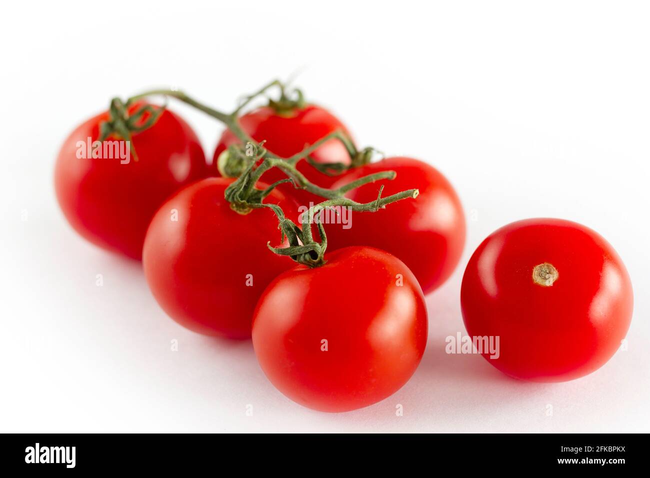 cherry tomatoes on a white background Stock Photo - Alamy