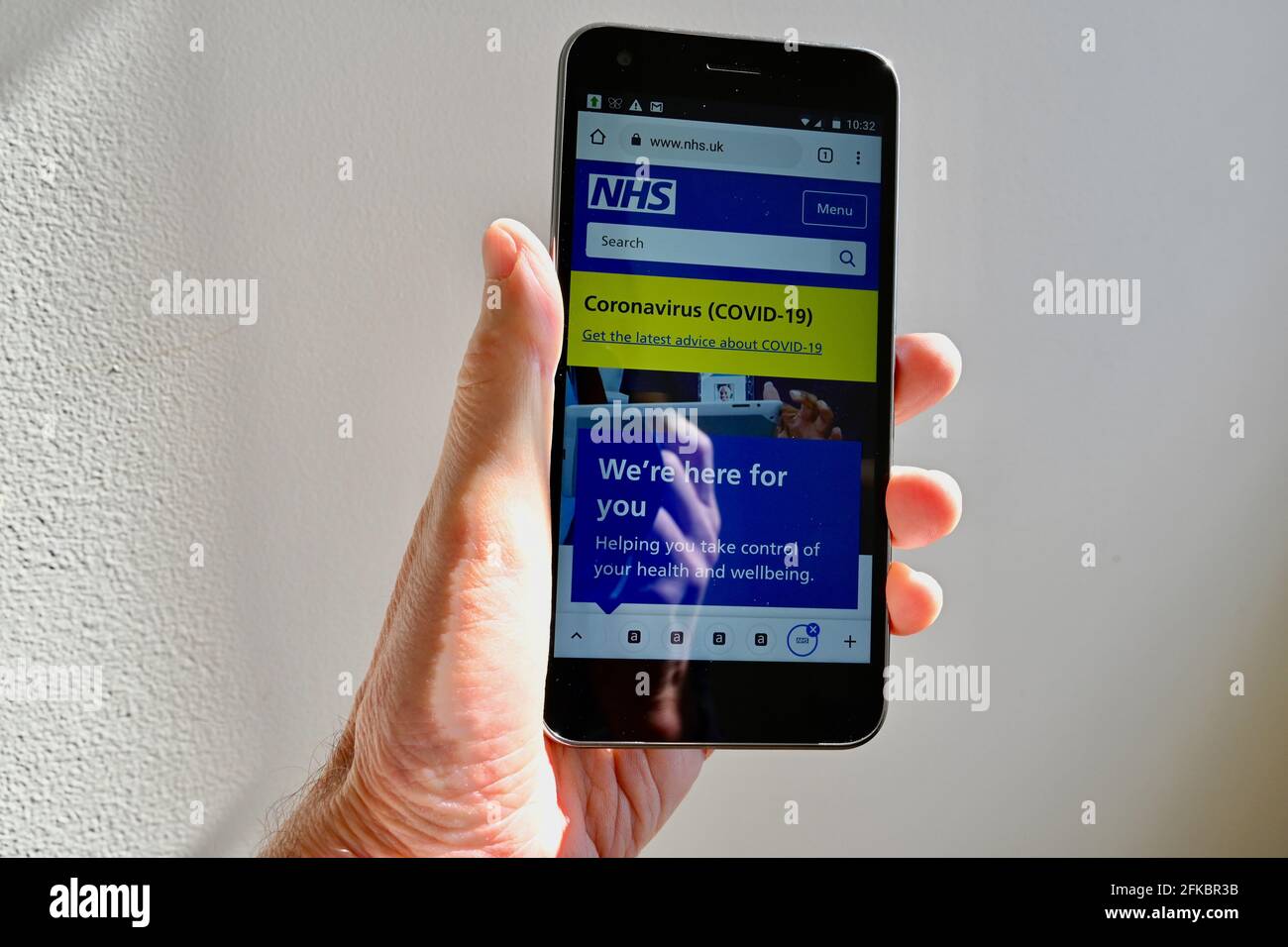 NHS Website Coronavirus (COVID-19) seen on a mobile phone. Stock Photo