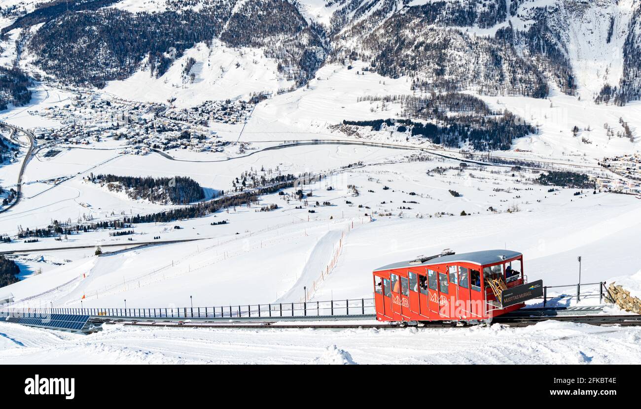 Tourists enjoying the journey on funicular in the snowy landscape, Muottas Muragl, Samedan, Engadine, Graubunden, Switzerland, Europe Stock Photo