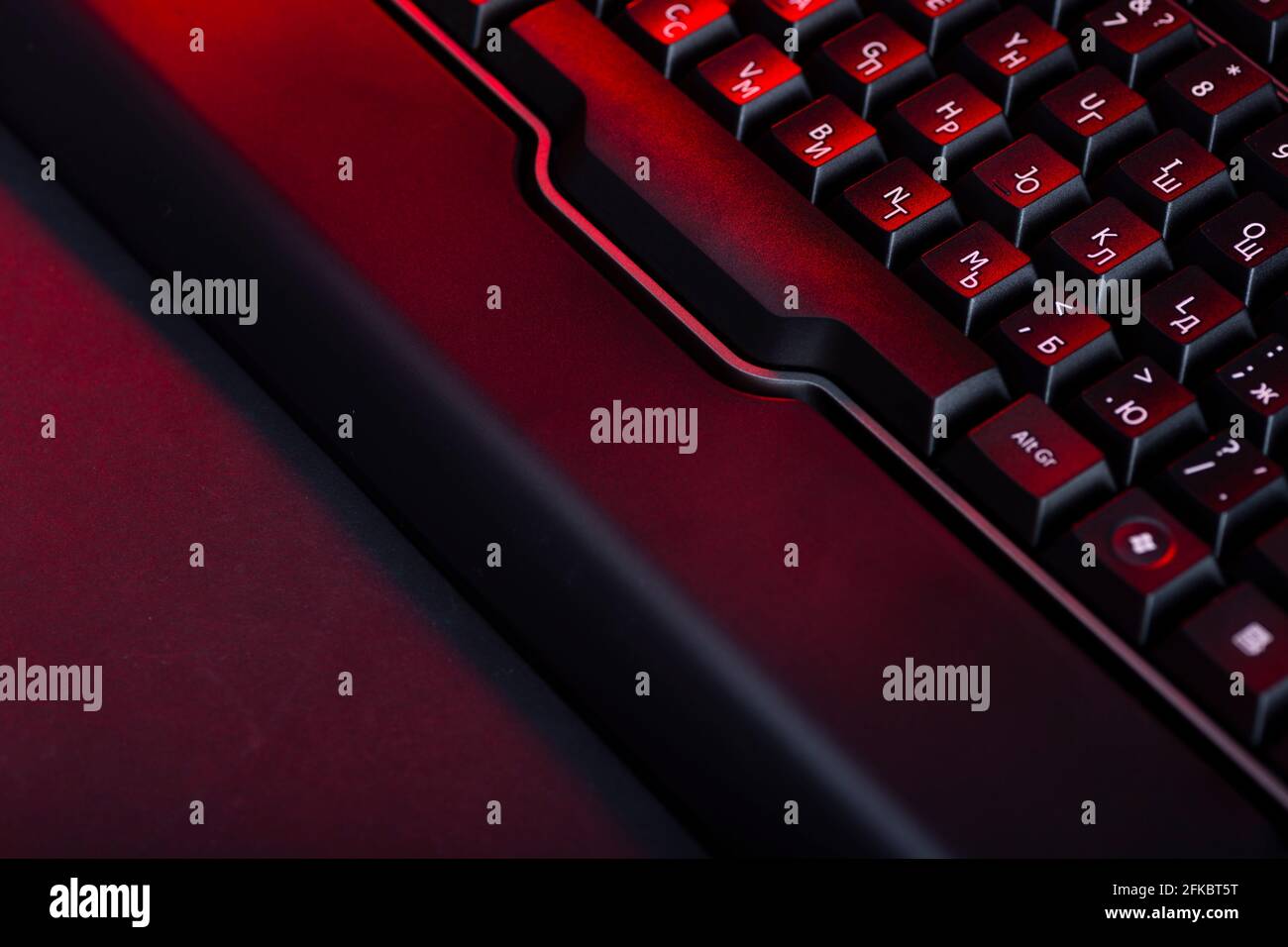 Gaming computer keyboard on a dark background. Stock Photo