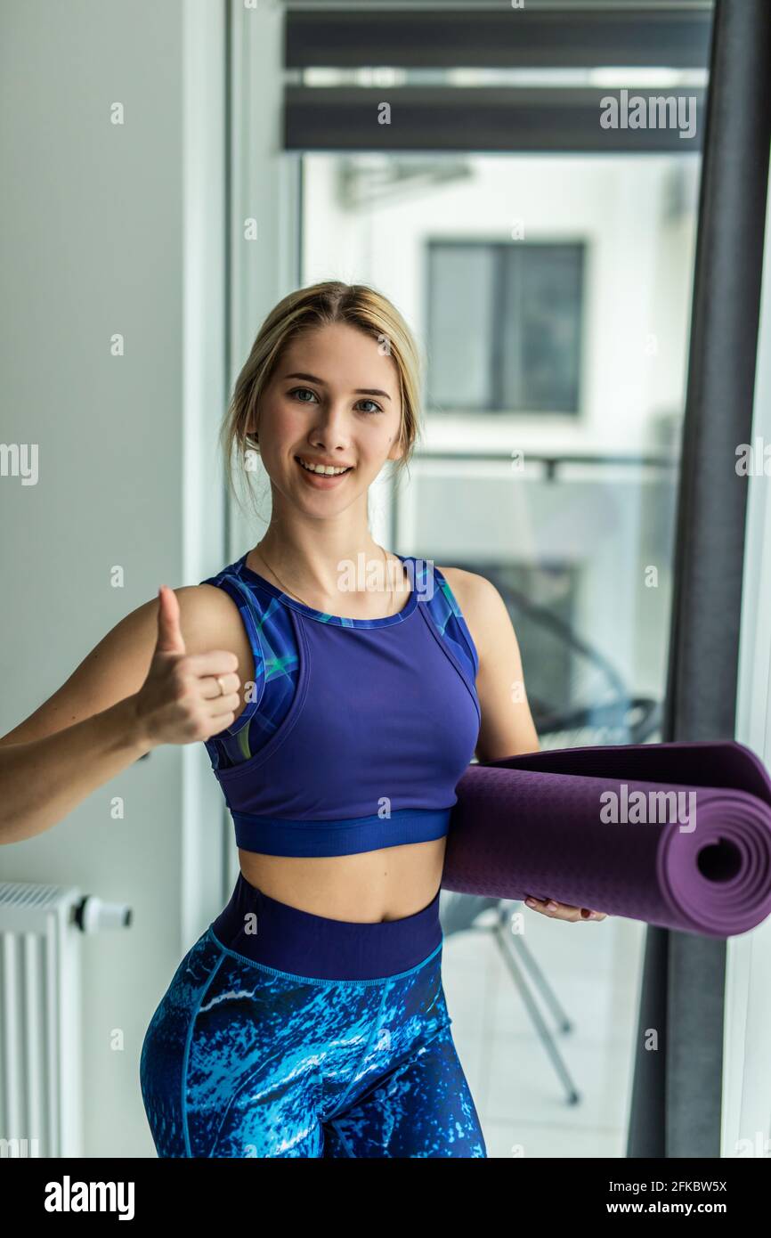 Portrait of sporty woman, yoga, pilates or other fitness instructor,  looking at camera, attractive successful female coach wearing sportswear,  grey br Stock Photo - Alamy