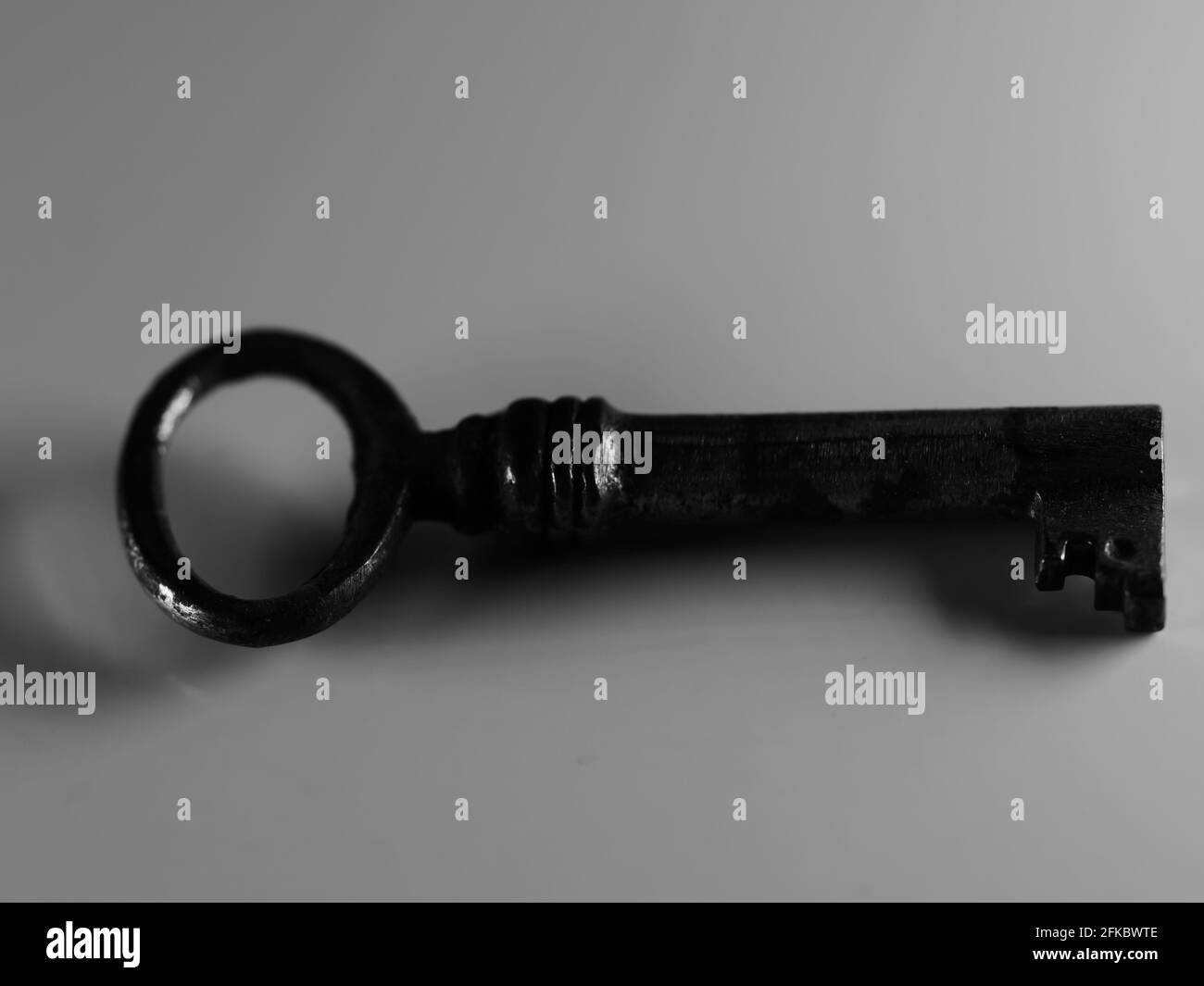 A golden key isolated on white background. Old rusty door key. Antique