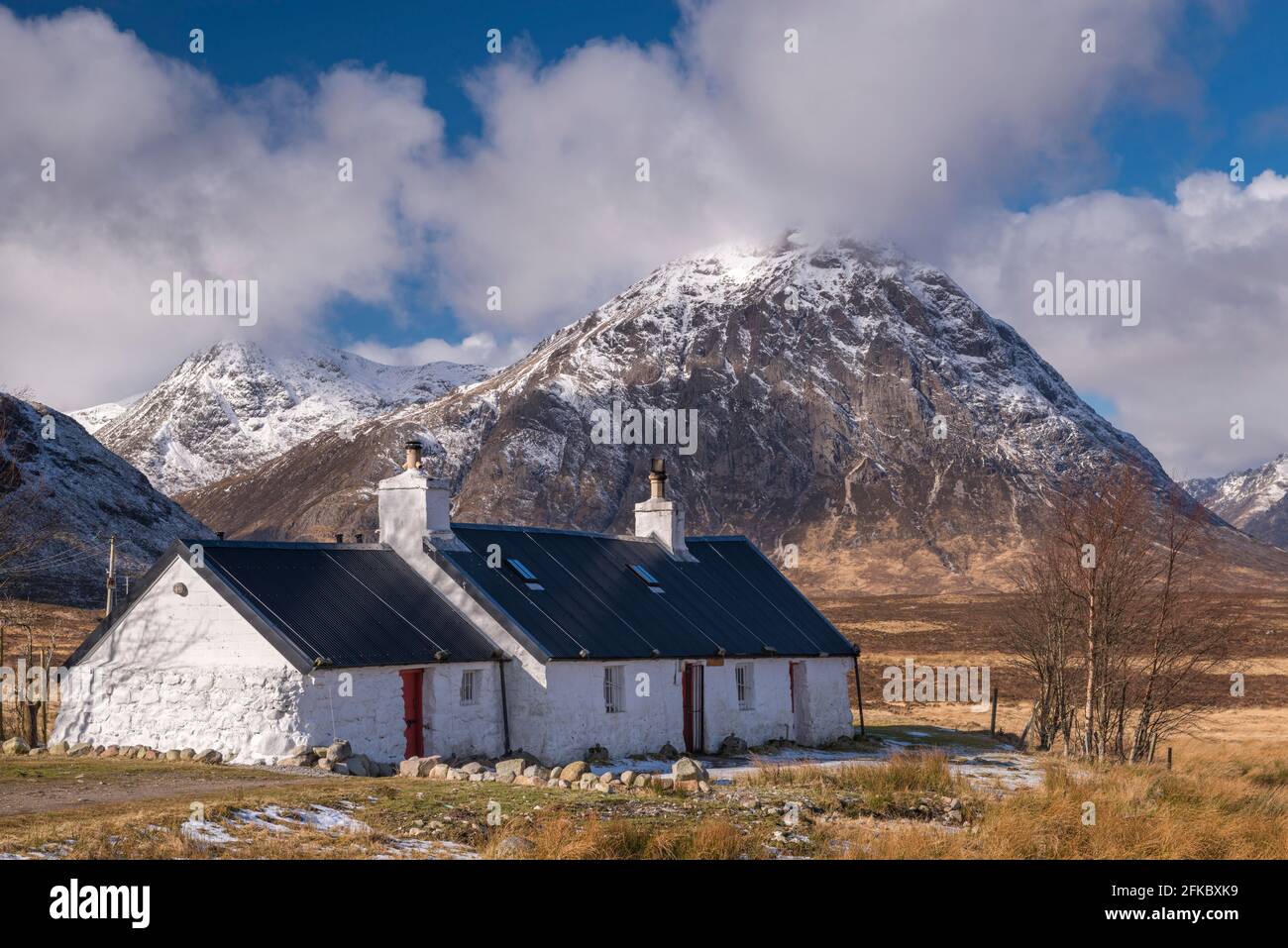 Black Rock Cottage bothy on Rannoch Moor with a snow dusted Buachaille Etive Mor looming behind in winter, Highlands, Scotland, United Kingdom, Europe Stock Photo