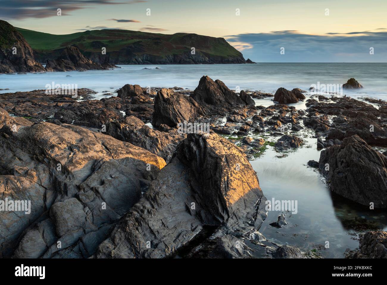 Evening sunlight on the rocky shores of Hope Cove, Devon, England, United Kingdom, Europe Stock Photo