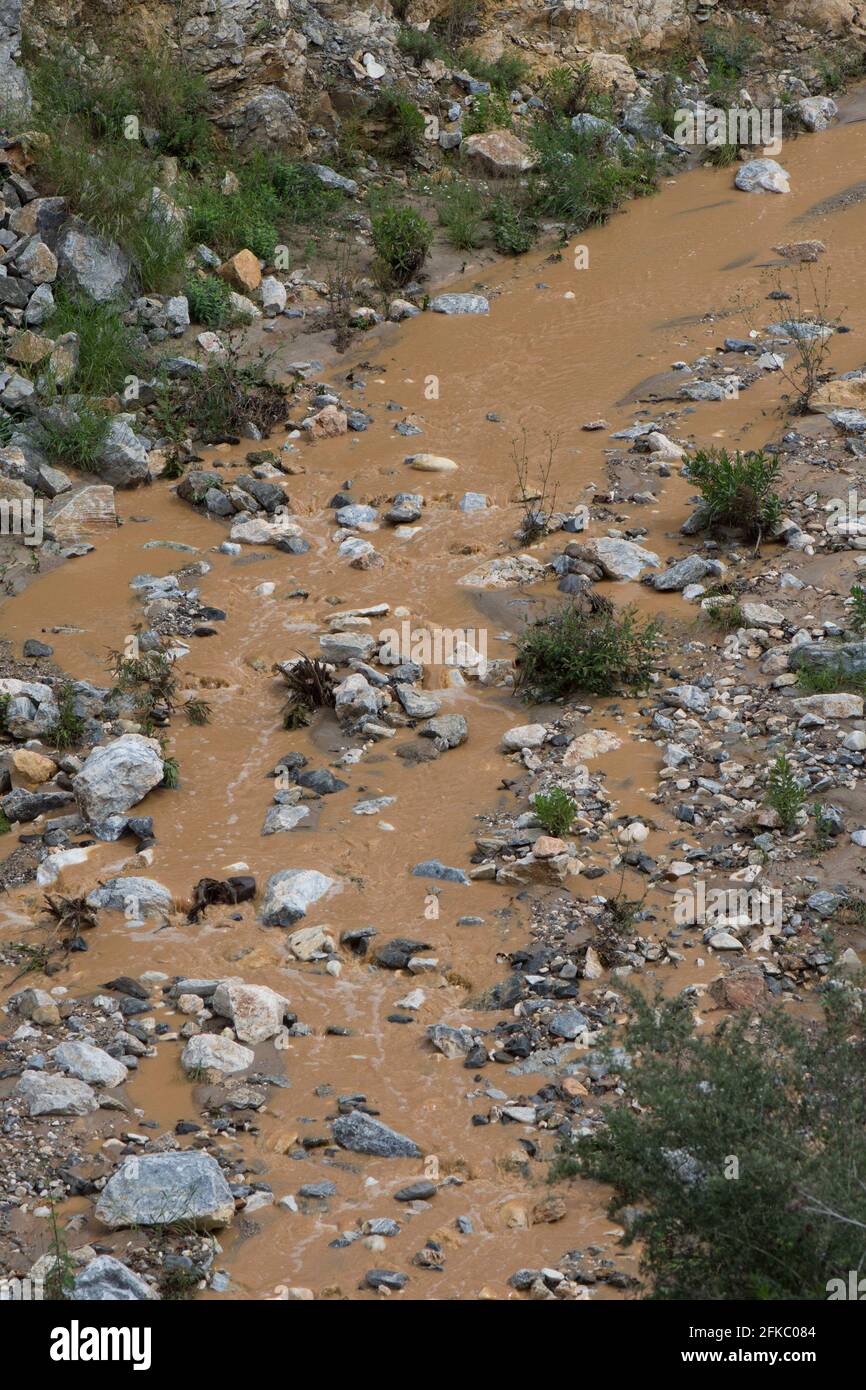 Stream flowing muddy water after torrential rainfall. Andalusia, Spain. Stock Photo
