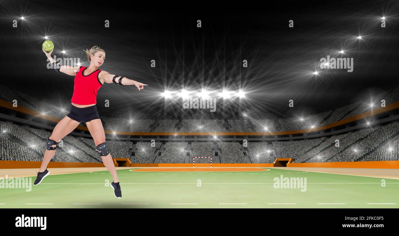 Composition of female handball player in air throwing ball on handball pitch with spotlights Stock Photo