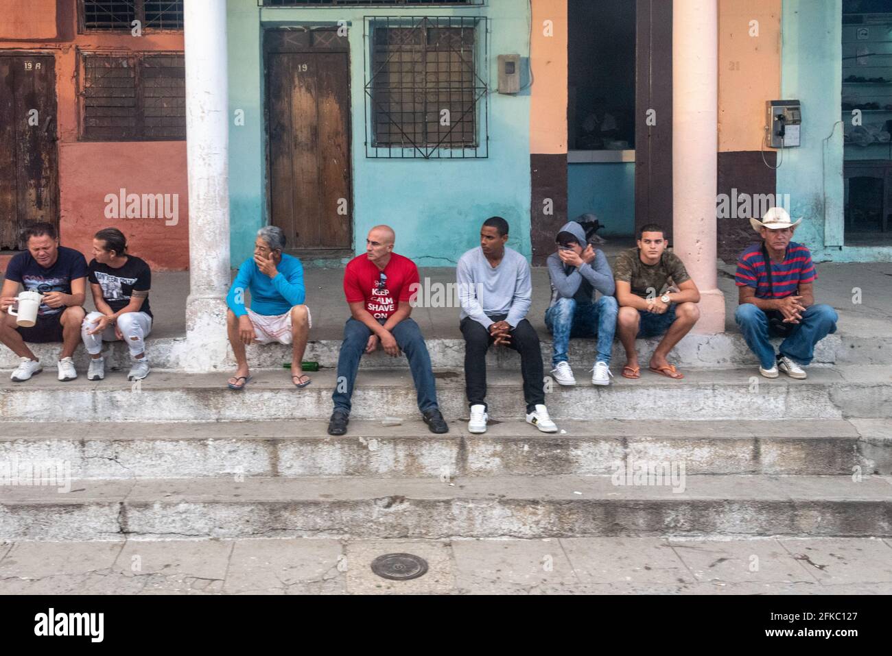 Lifestyle is Cuban small town, group of people sitting in porch doing