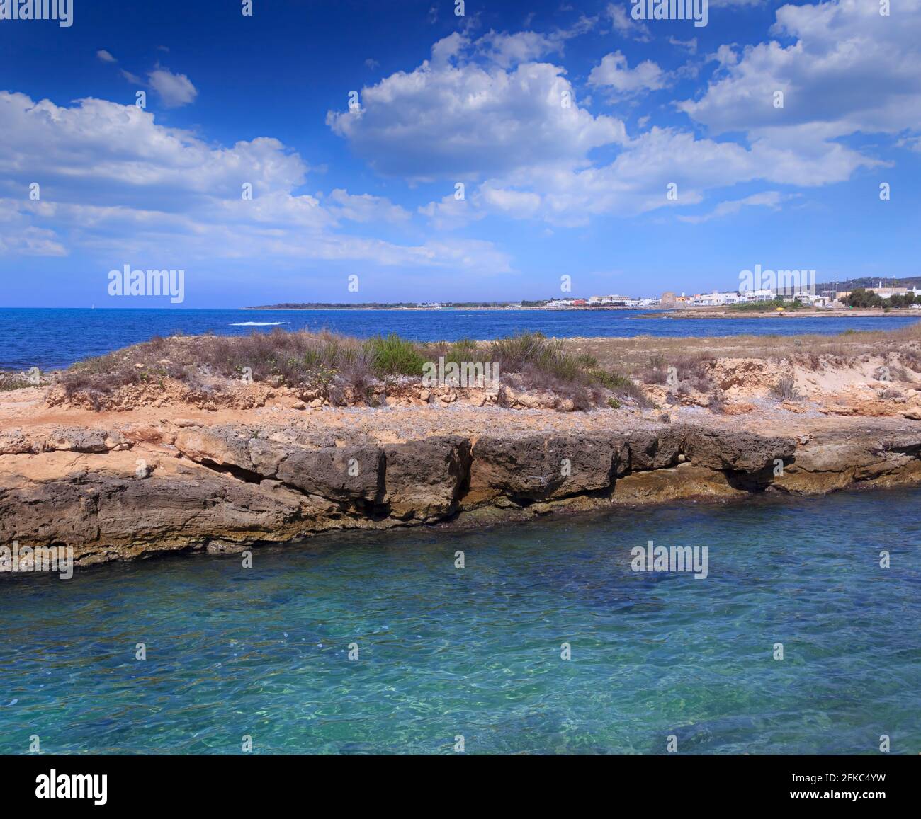 Torre Mozza beach in Salento, Apulia (Italy). The ruined watchtower overlooks the long beach of Torre Mozza, with fine sand, Stock Photo
