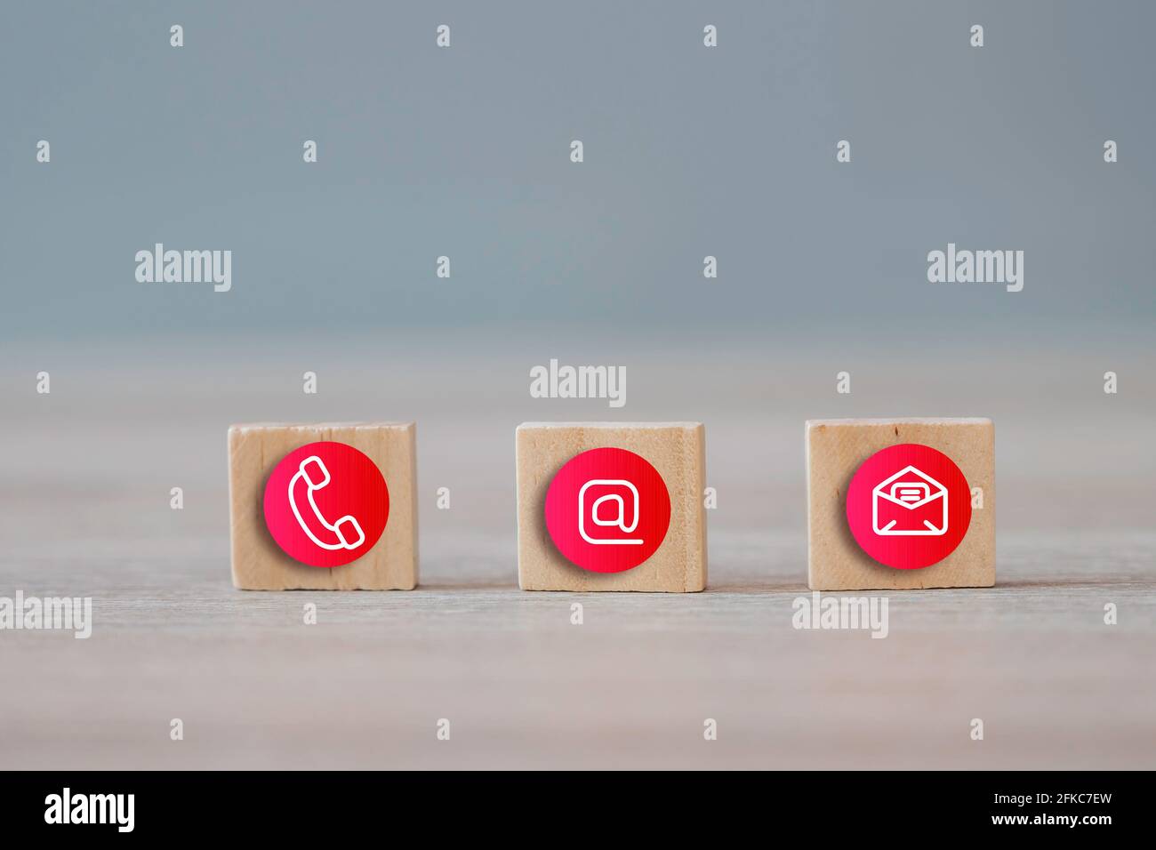 Hotline support contact communication concept. Contact us communication icons on wood cubes. Stock Photo