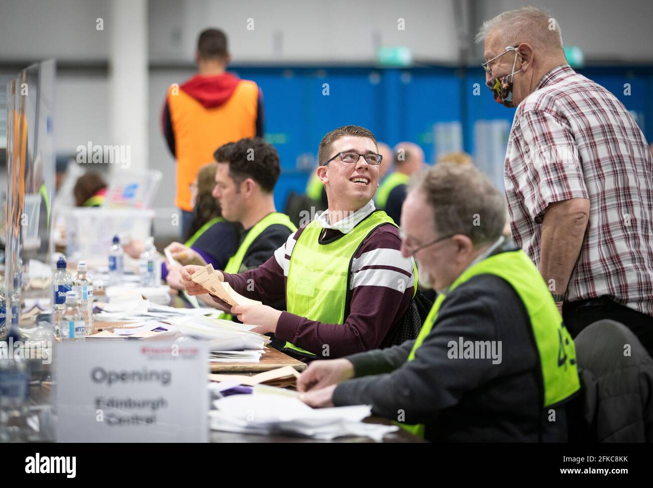 The City of Edinburgh Council elections staff at the Royal Highland Centre, Edinburgh, verify the first postal votes returned to the Counting Officer ahead of the Scottish Parliament Election 2021. Picture date: Friday April 30, 2021. Stock Photo