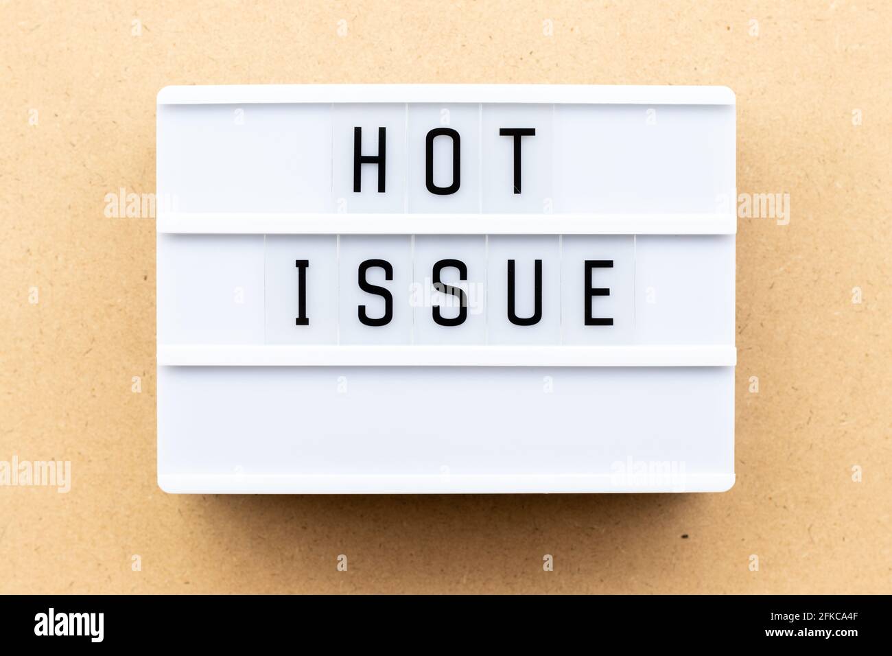Light box with word hot issue on wood background Stock Photo