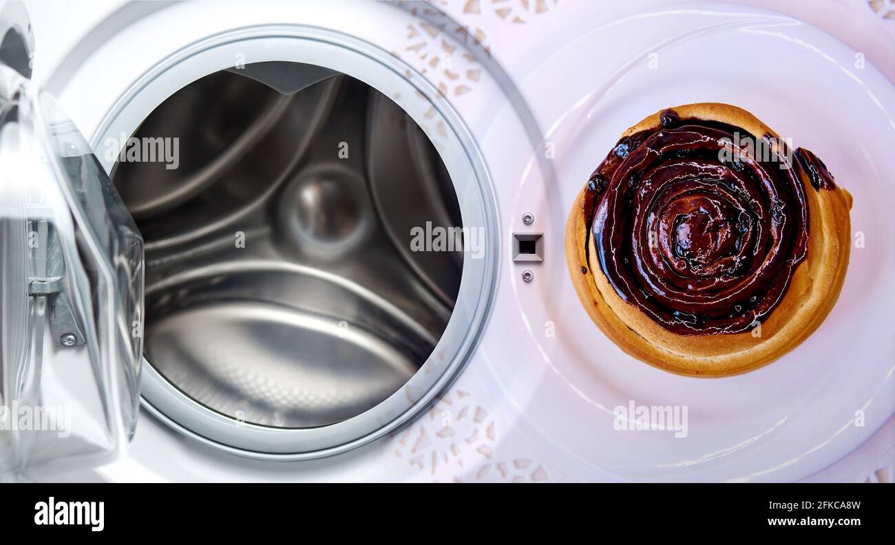 Washing chocolate stains. Open washing machine and chocolate cake Stock