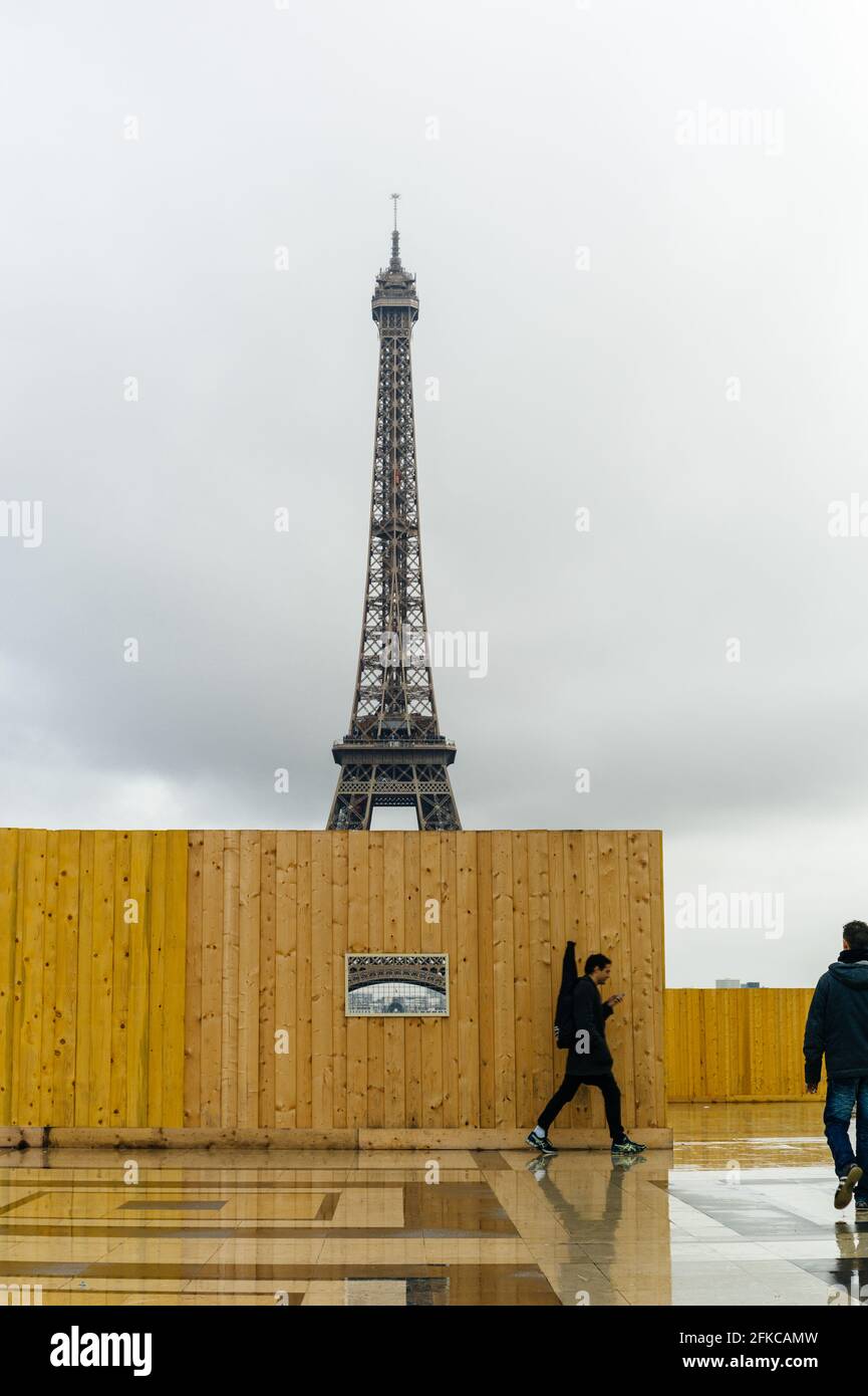People looking at and walking around the construction site secure