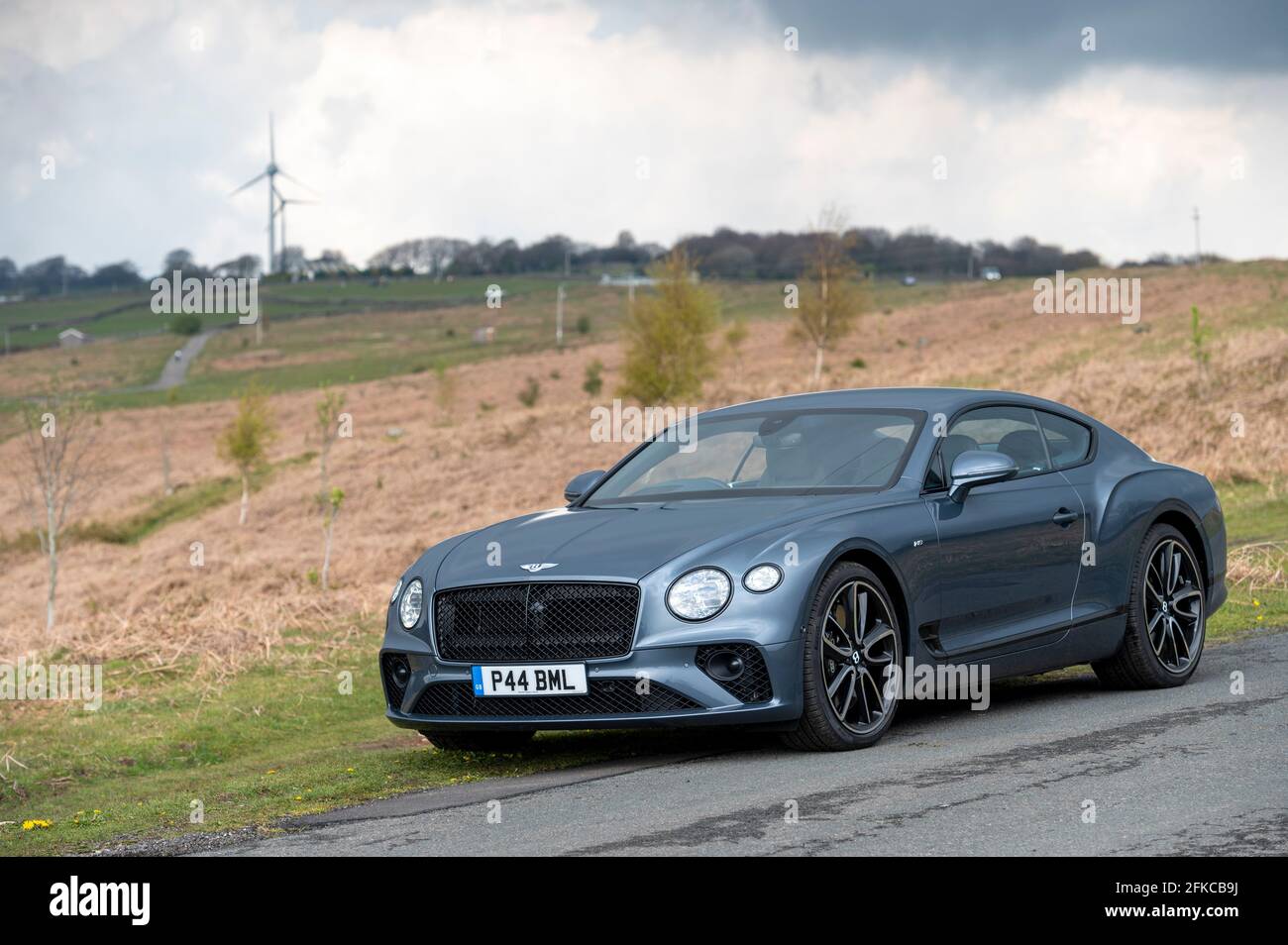 A Bentley Continental GT V8 luxury sports car pictured against a backdrop of the Rhymney Valley in South East Wales. Stock Photo