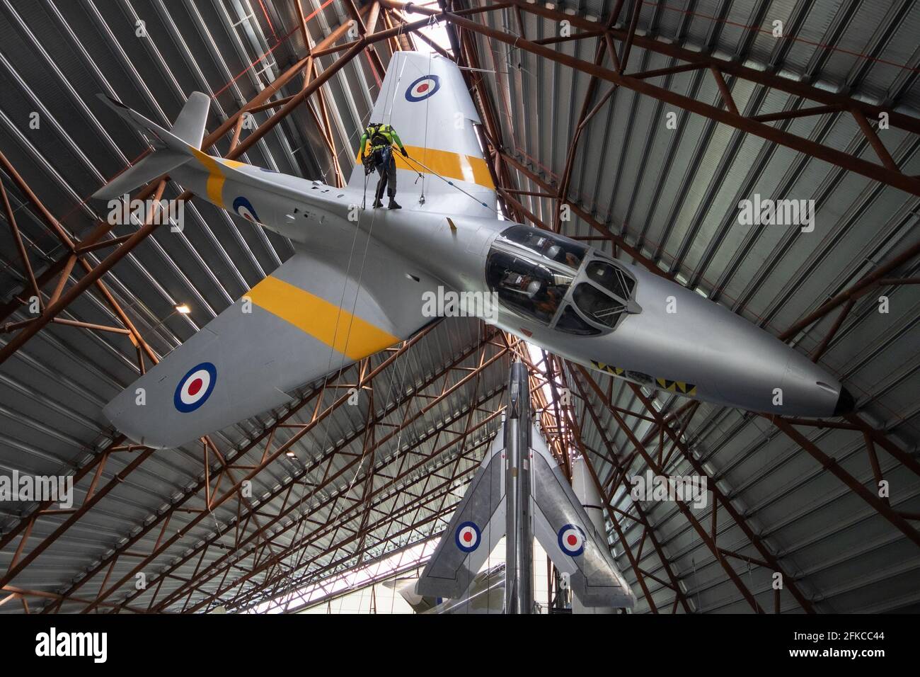 Cosford, United Kingdom, 30th April 2021. RAF Museum Cosford's National Cold War Exhibition hangar features a number of suspended and large aircraft, some of which are over a 100ft in the air. With limited or difficult access for museum staff, an annual clean of the larger and suspended aircraft along with inspection of the suspension cables is undertaken by a specialist team using a combination of both rope access and mechanical platforms. Credit: Paul Bunch/Alamy Live News Stock Photo