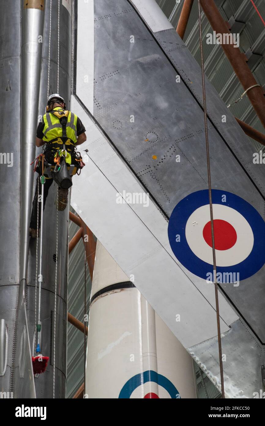 Cosford, United Kingdom, 30th April 2021. RAF Museum Cosford's National Cold War Exhibition hangar features a number of suspended and large aircraft, some of which are over a 100ft in the air. With limited or difficult access for museum staff, an annual clean of the larger and suspended aircraft along with inspection of the suspension cables is undertaken by a specialist team using a combination of both rope access and mechanical platforms. Credit: Paul Bunch/Alamy Live News Stock Photo