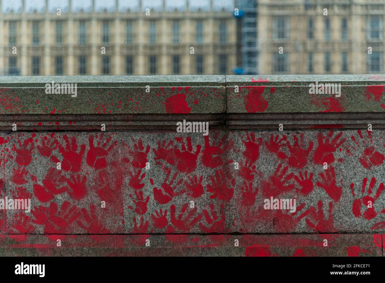 London, UK. 30th Apr, 2021. People have added a Knife Crime Memorial wall, opposite, with red hand prints instead of hearts - The national Covid Memorial Wall outside St Thomas' Hospital on the southbank is now largely completed. Mourners have drawn hearts by hand on a wall opposite Parliament in London. Credit: Guy Bell/Alamy Live News Stock Photo