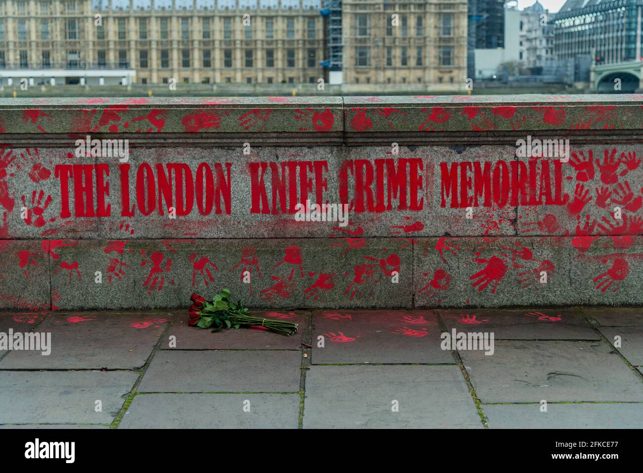 London, UK. 30th Apr, 2021. People have added a Knife Crime Memorial wall, opposite, with red hand prints instead of hearts - The national Covid Memorial Wall outside St Thomas' Hospital on the southbank is now largely completed. Mourners have drawn hearts by hand on a wall opposite Parliament in London. Credit: Guy Bell/Alamy Live News Stock Photo