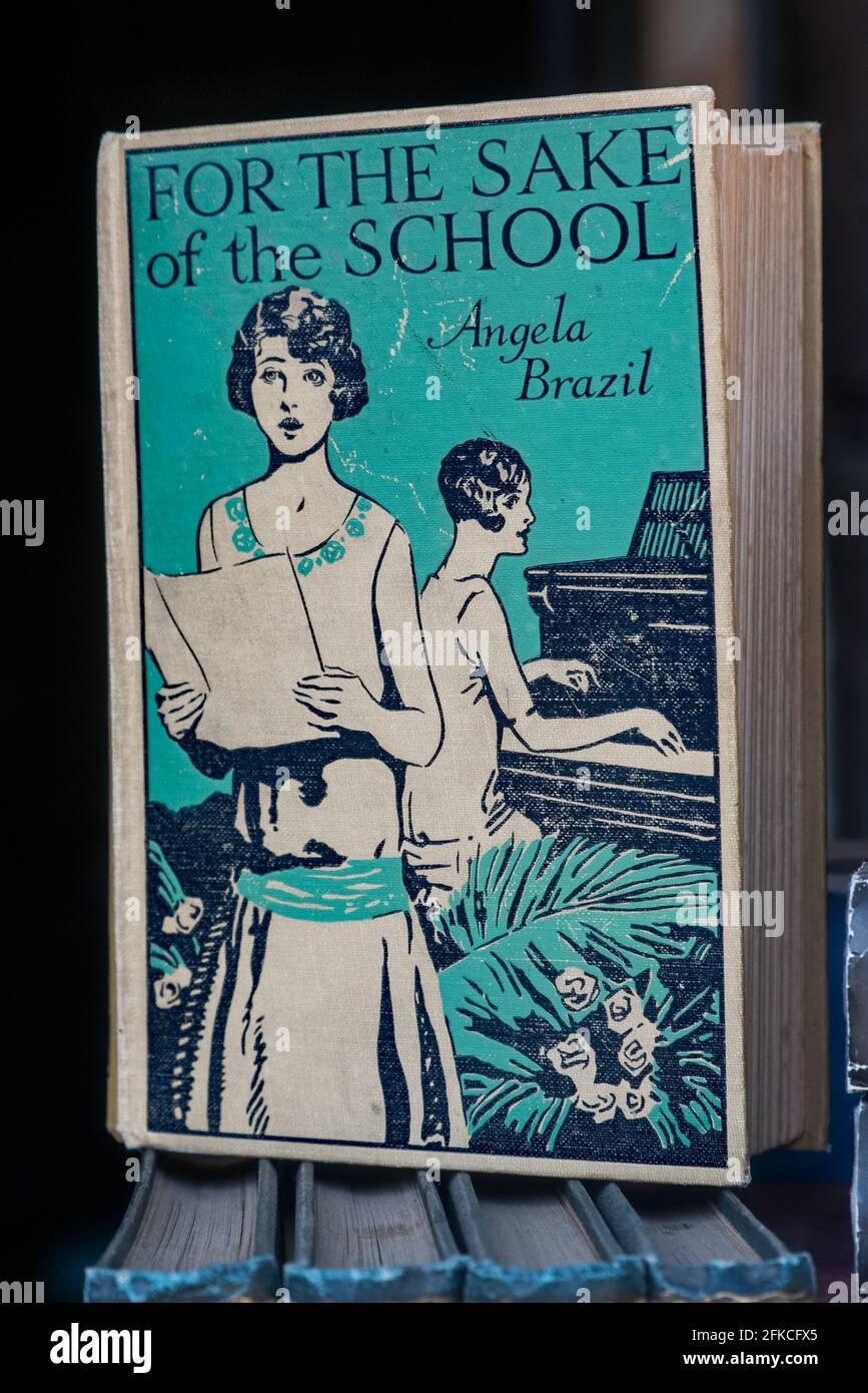 Vintage secondhand copy of 'For The Sake of the School' by Angela Brazil (1868-1947) in the window of a secondhand bookshop in Edinburgh, Scotland, UK Stock Photo