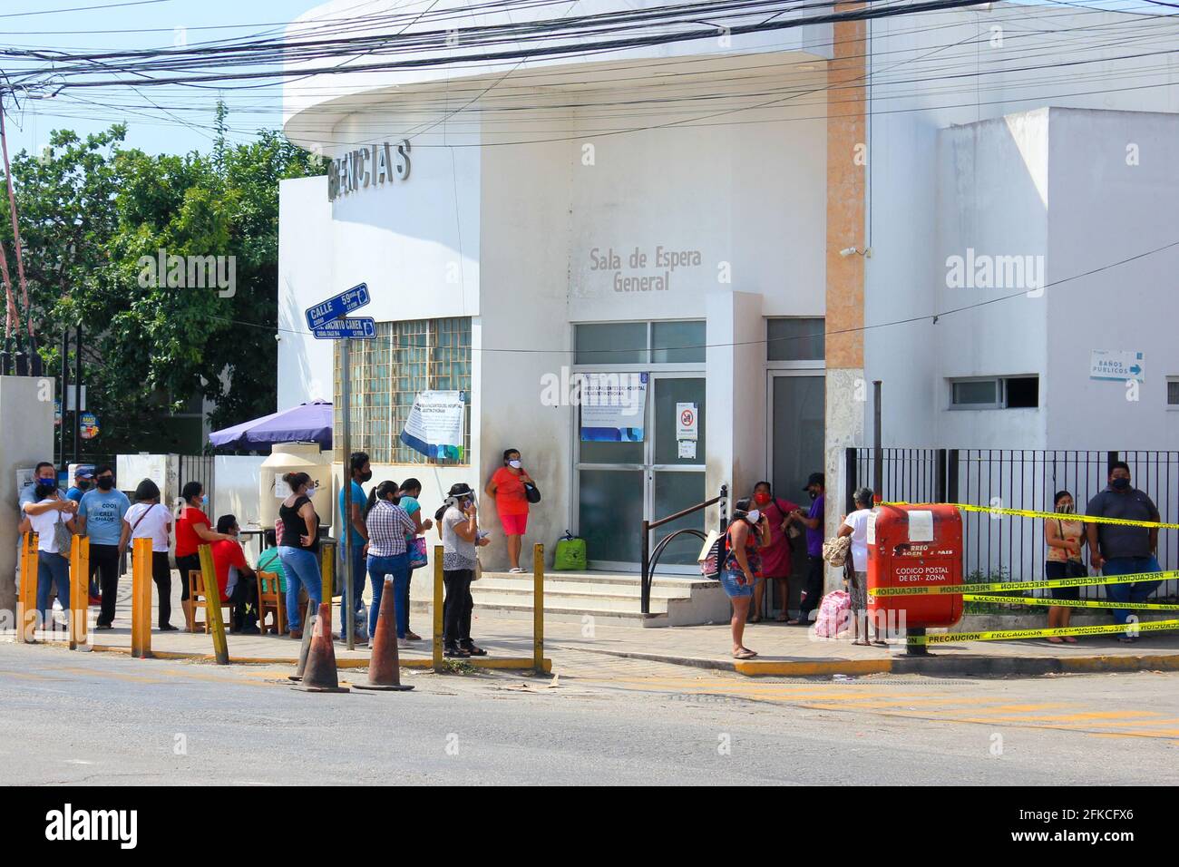Mexican people standing in line in front of the Emergency entrance of a Public Hospital in Merida Mexico during the Covid-19 Pandemic Stock Photo