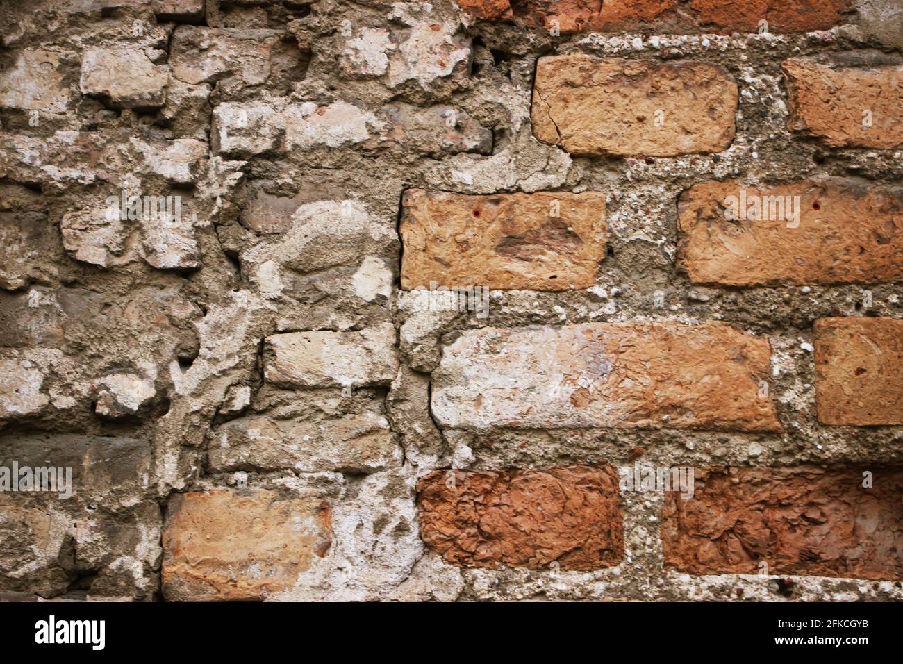 Weathered historical old red brick wall texture. Vintage background. Stock Photo