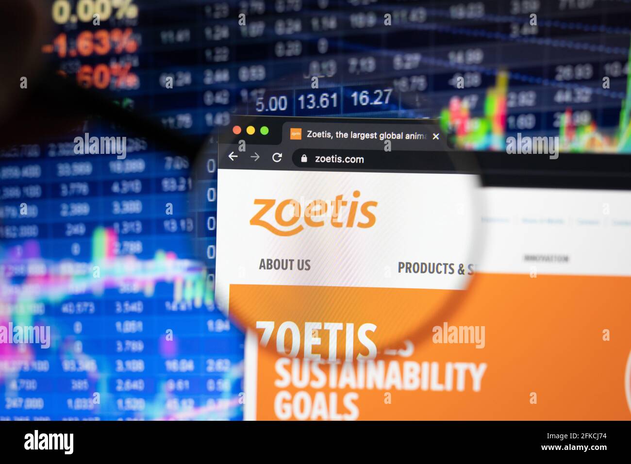 Zoetis company logo on a website with blurry stock market developments